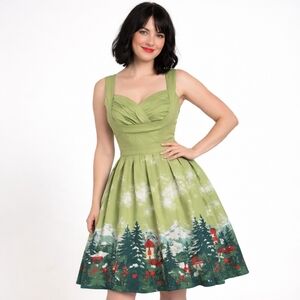 Whimsical green fit & flare dress featuring a storybook forest village border